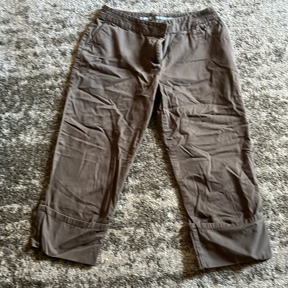 Womens below waist cropped pants with rolled cuffs.